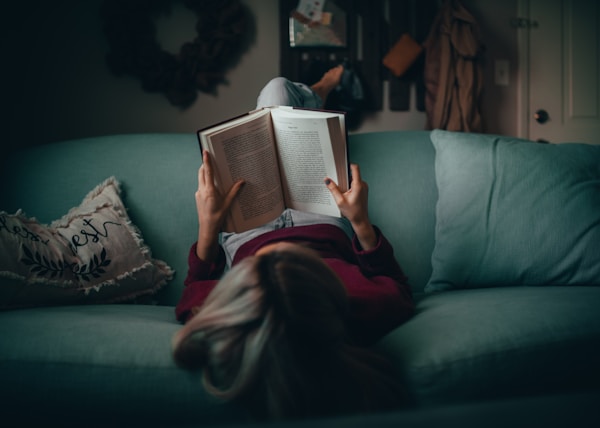 woman in red shirt reading book