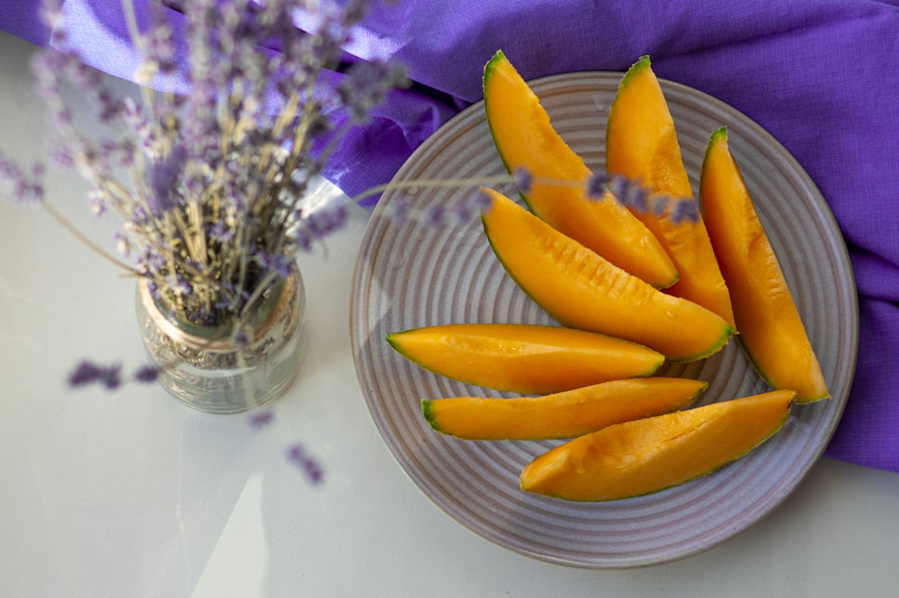 sliced orange on white ceramic plate