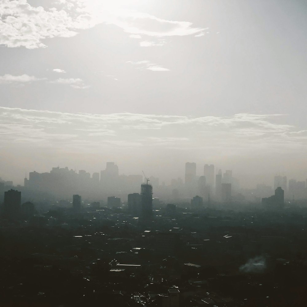 city skyline under white clouds during daytime