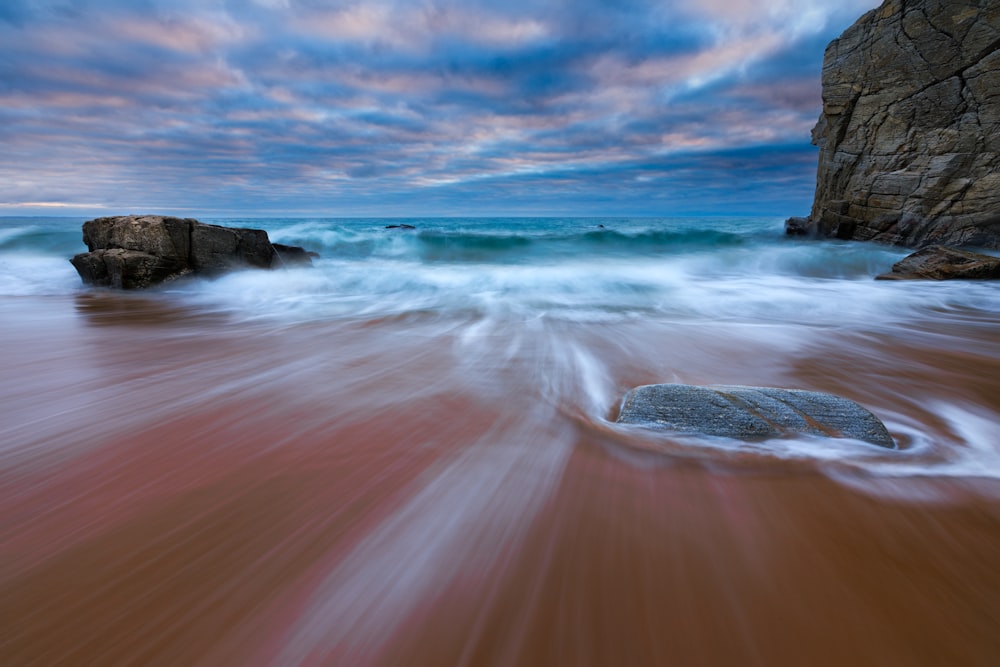 ocean waves crashing on shore during daytime