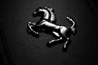 Golden lion emblem shining against a sleek black background with modern red accents.