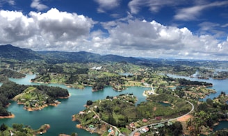 aerial view of city near lake under cloudy sky during daytime