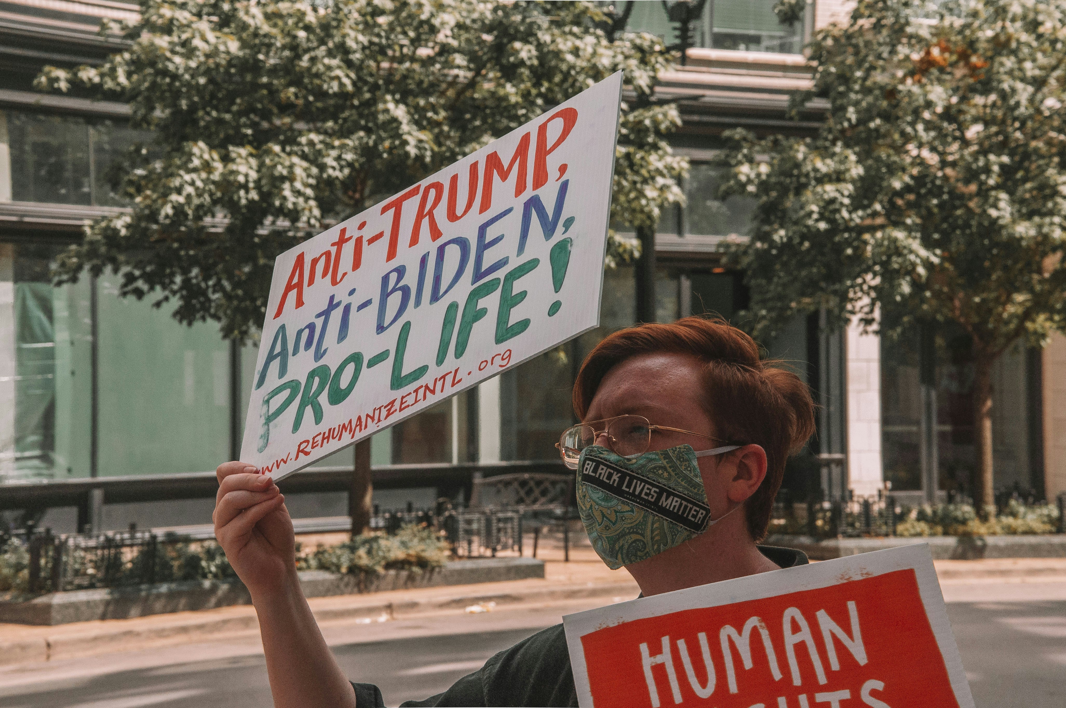 woman holding white and red no parking sign democrat zoom background
