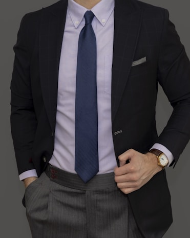 man in black suit jacket and blue necktie
