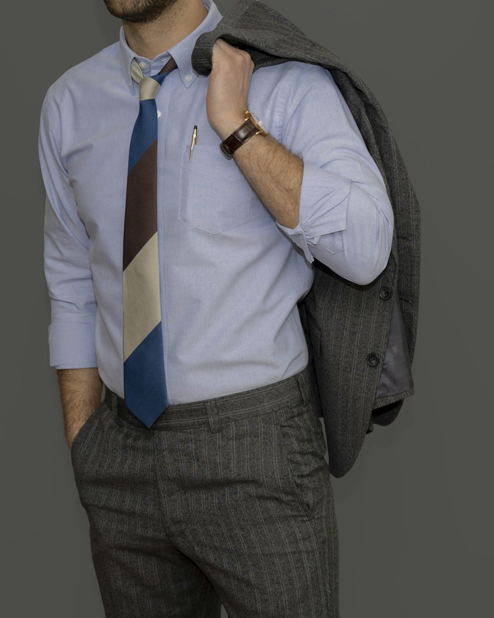 man in gray vest and white dress shirt