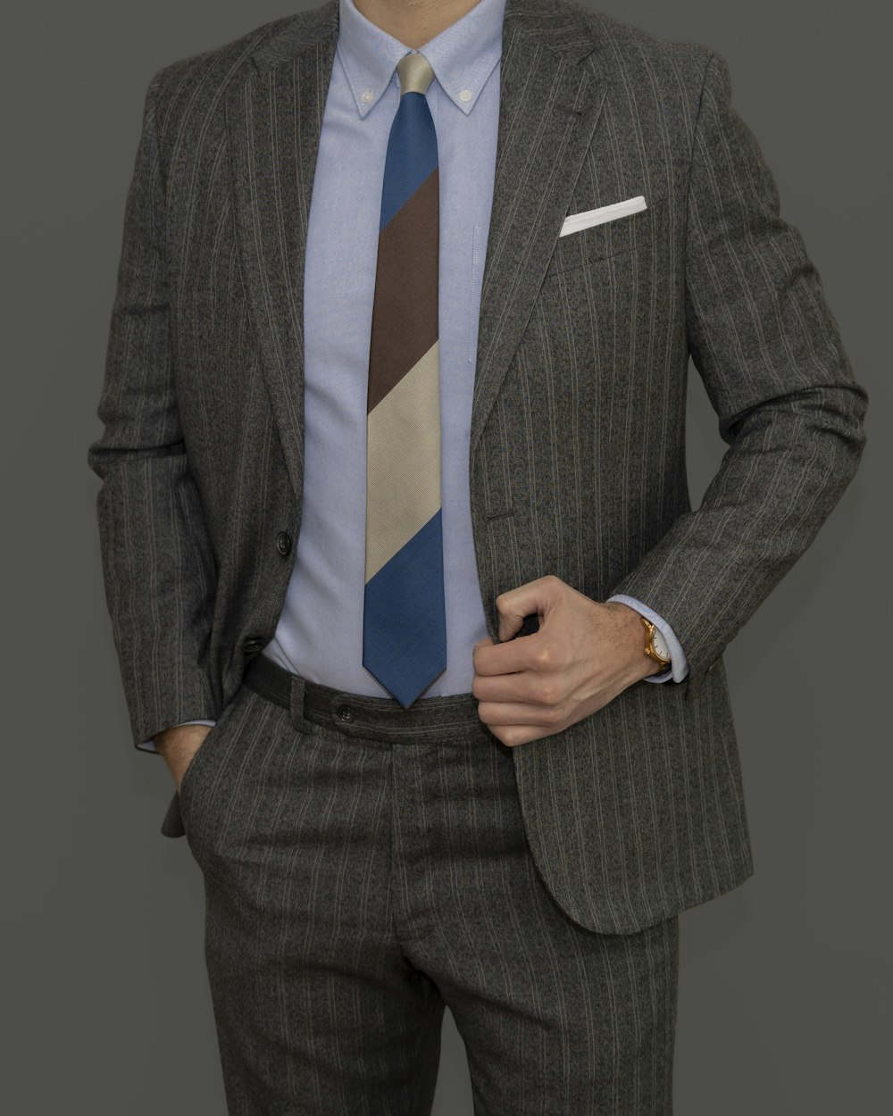 man in gray suit jacket and blue necktie