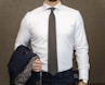 man in white dress shirt with black and white polka dots necktie