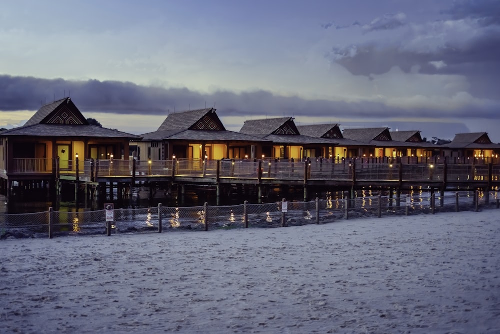 brown wooden houses on body of water during daytime