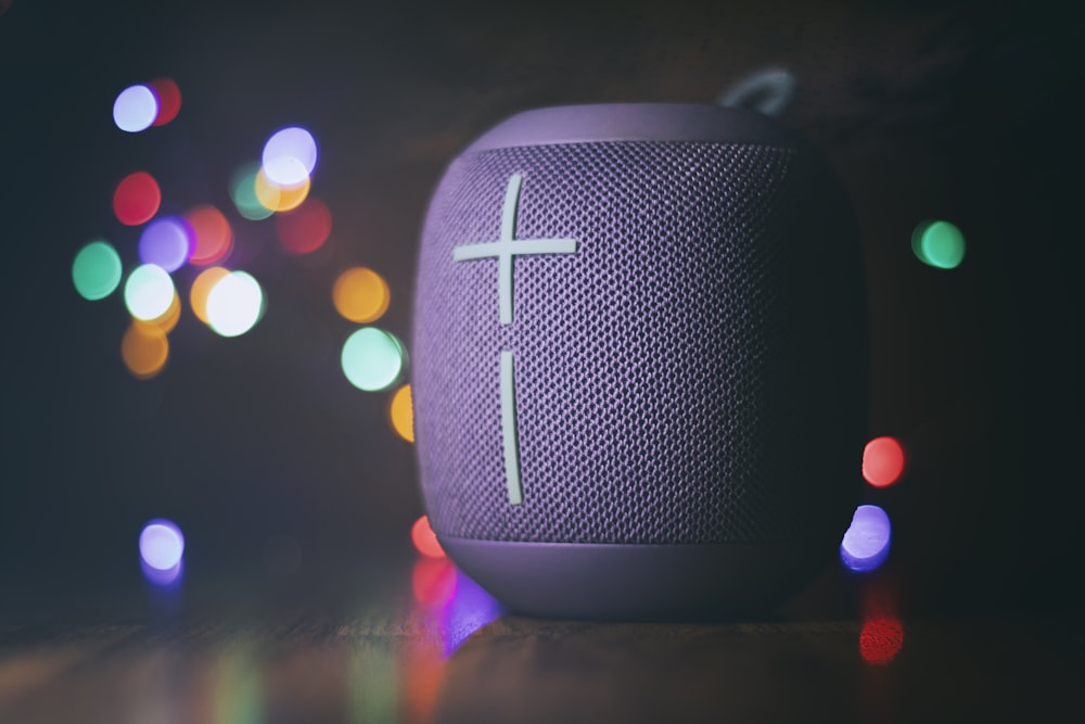 black and gray speaker on brown wooden table