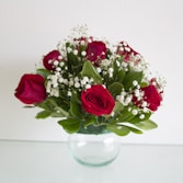 red roses in clear glass vase
