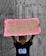 A child stands holding a handwritten cardboard sign with the message 'I need my dad. It's time 4 change.' The child is wearing a T-shirt with the words 'Black Lives Matter' against a backdrop of wooden boards.