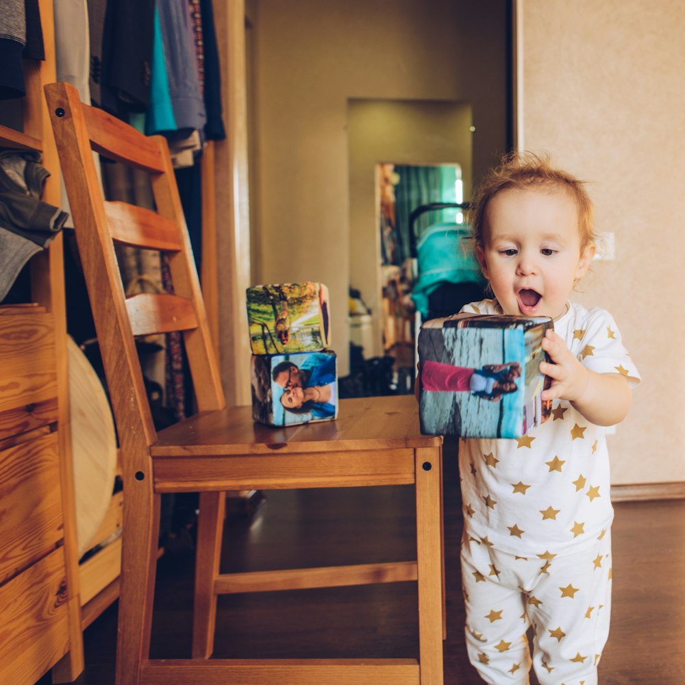 boy in white and blue pajama set holding white and red plastic cup