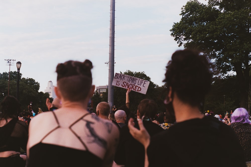 people standing near white post during daytime