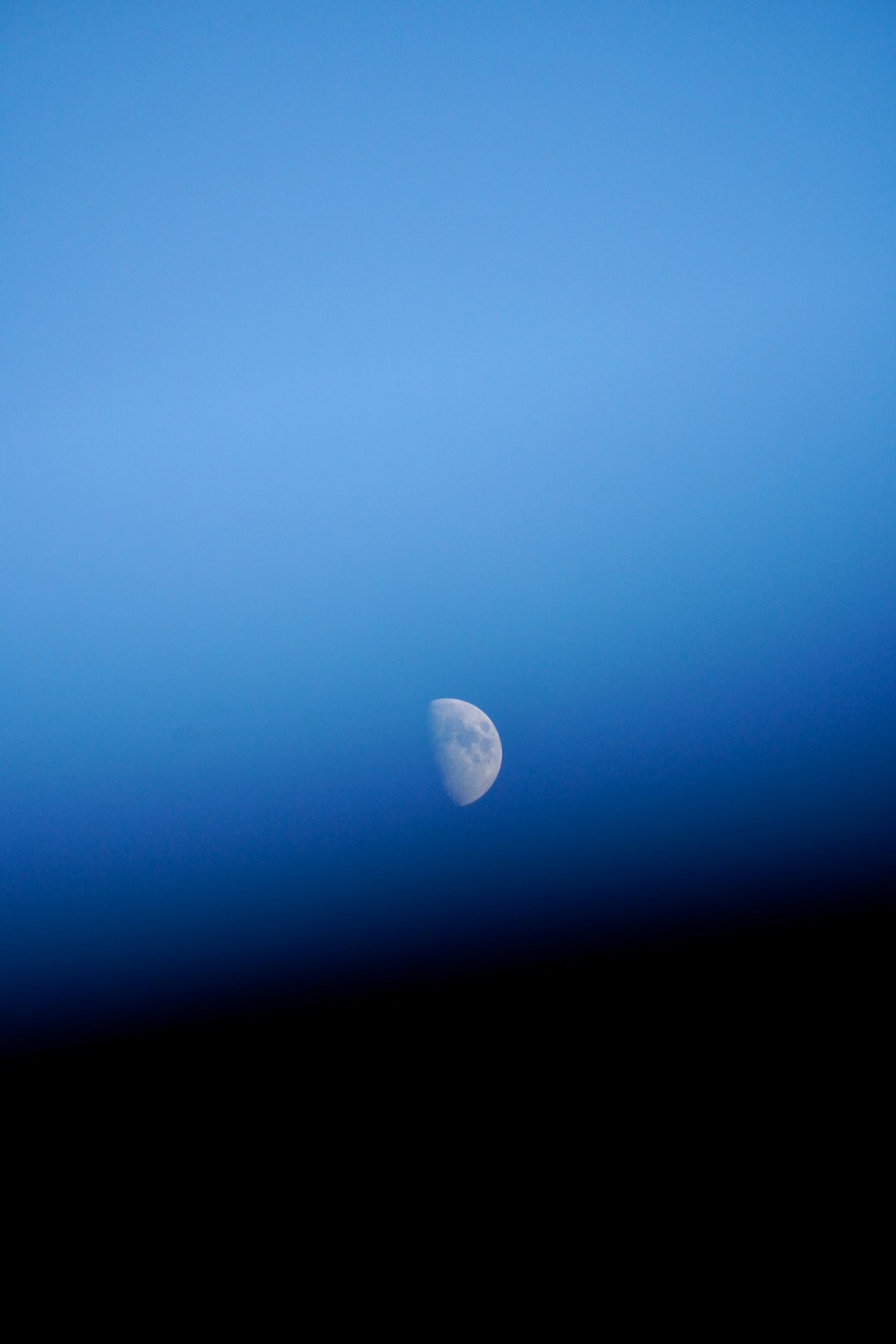 white moon in blue sky