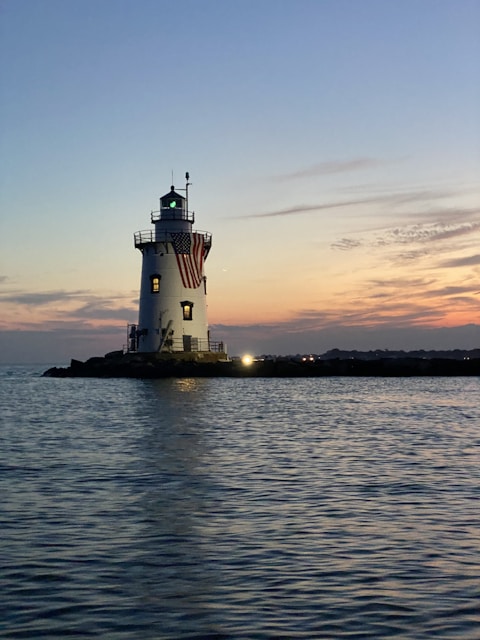 Best Quality Movers white lighthouse near body of water during sunset