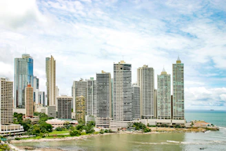 city buildings near body of water under blue sky during daytime