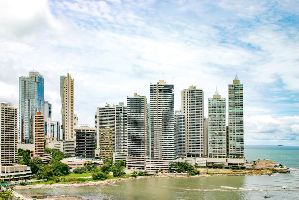 city buildings near body of water under blue sky during daytime