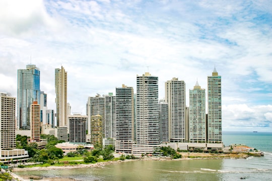 city buildings near body of water under blue sky during daytime in Panama City Panama