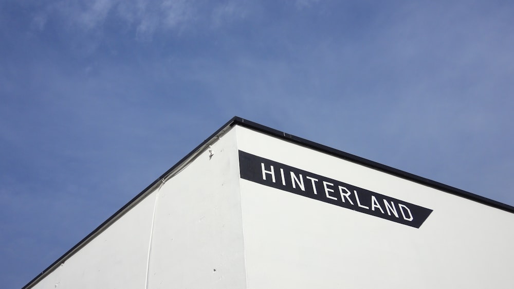 a white building with a black sign that reads hintterland