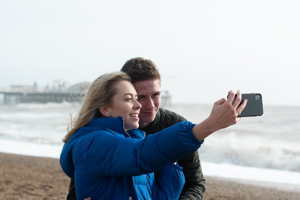 woman in blue jacket holding mans hand