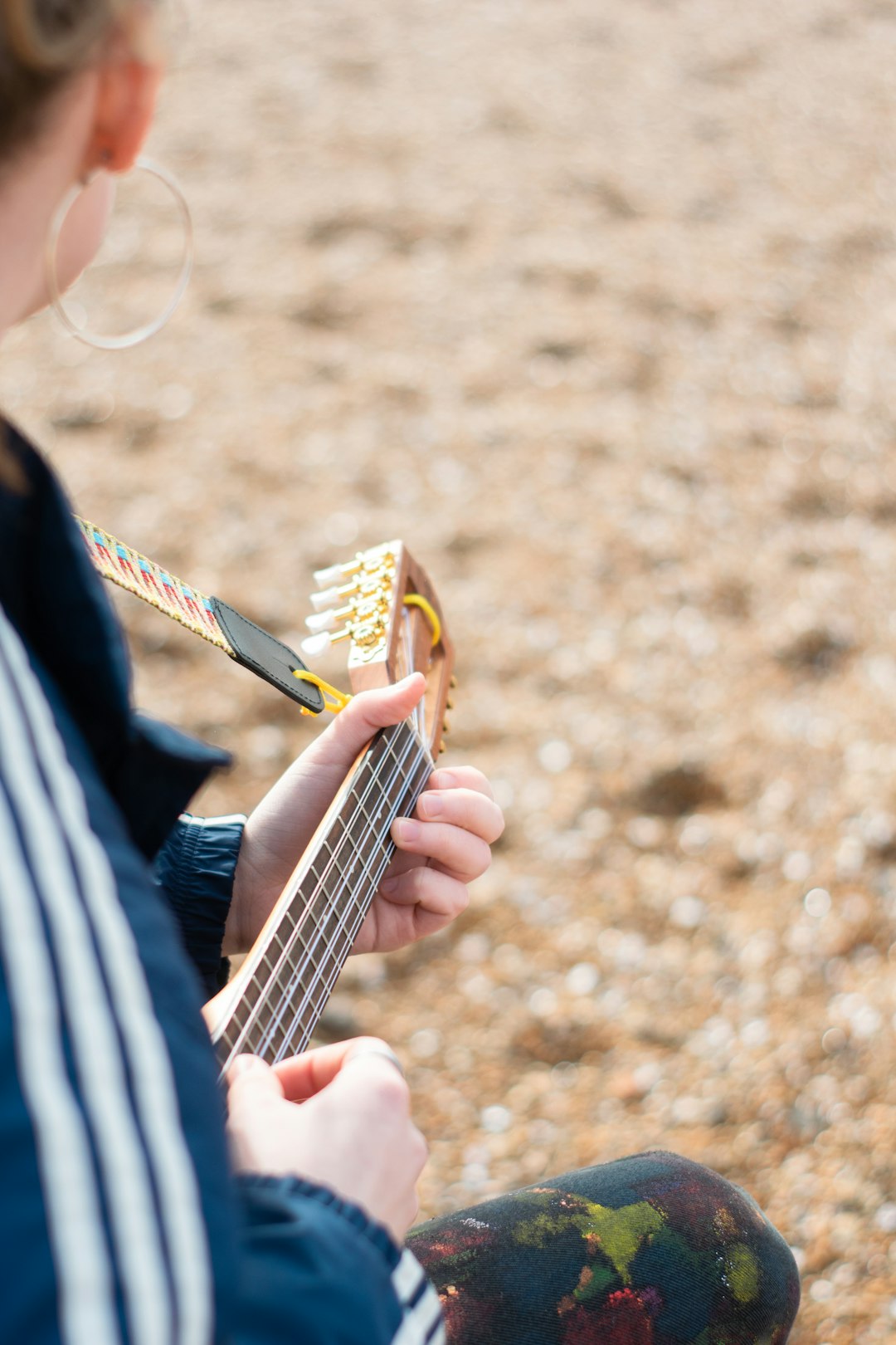 person playing guitar during daytime