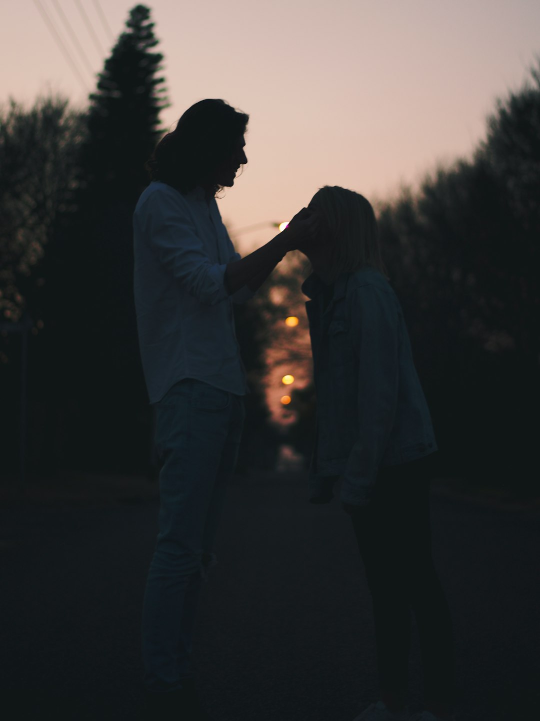 man and woman kissing during sunset