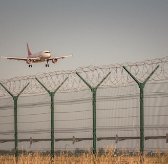 white airplane on mid air during daytime