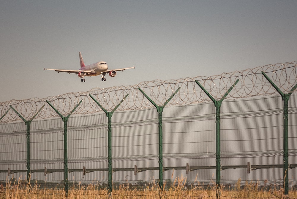 white airplane on mid air during daytime