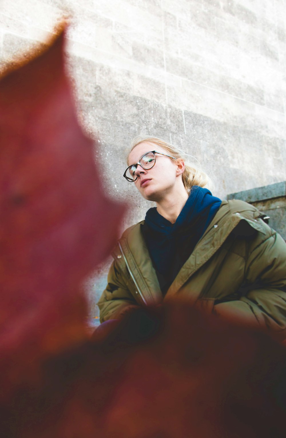 woman in black framed eyeglasses and brown coat