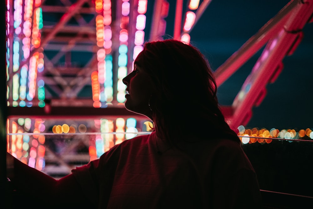 silhouette of woman standing near red light