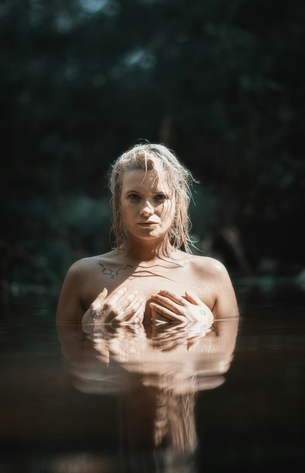 topless woman in water during daytime