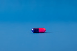 red and blue pill on blue surface