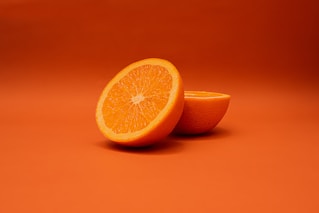 sliced lemon on orange surface