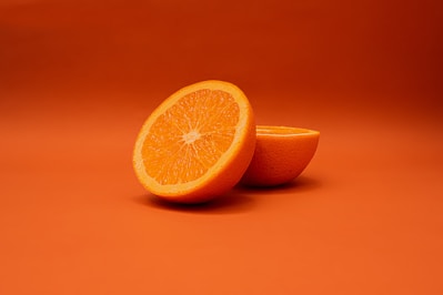 sliced lemon on orange surface