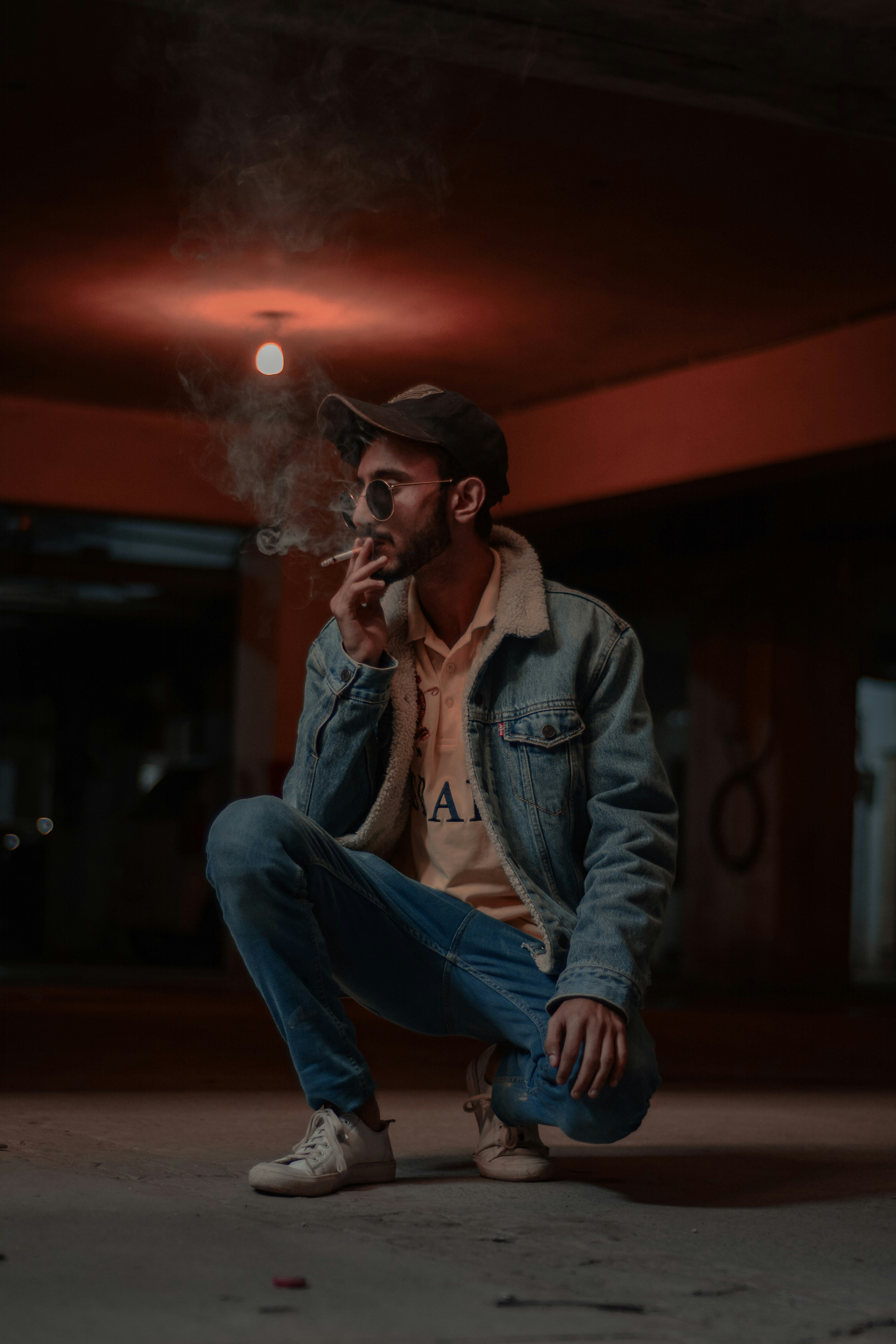 woman in blue denim jacket smoking