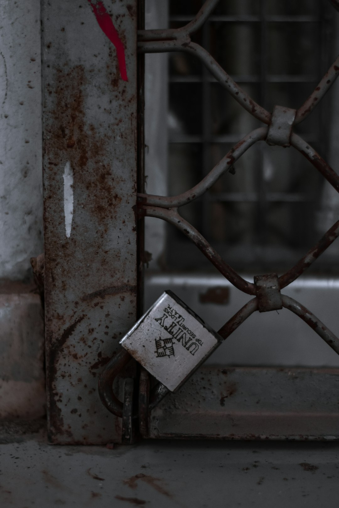 padlock on brown metal fence