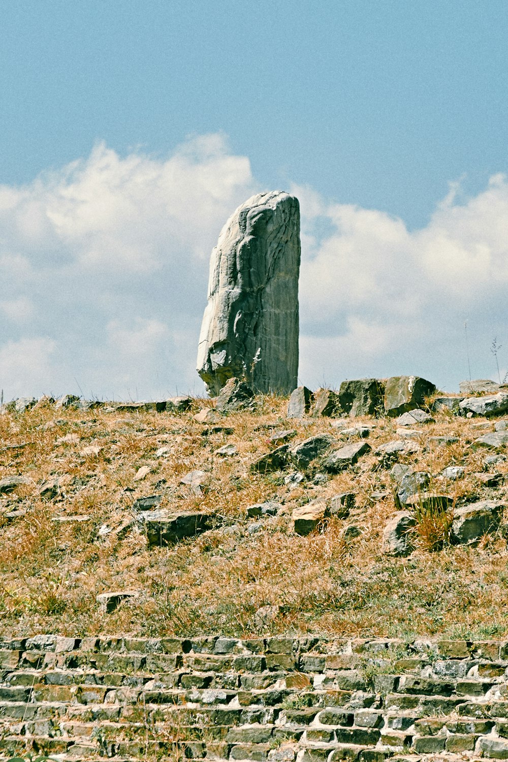 gray rock formation under white clouds during daytime