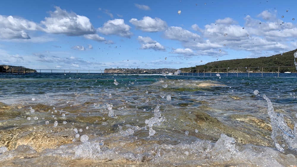 sea waves crashing on shore during daytime