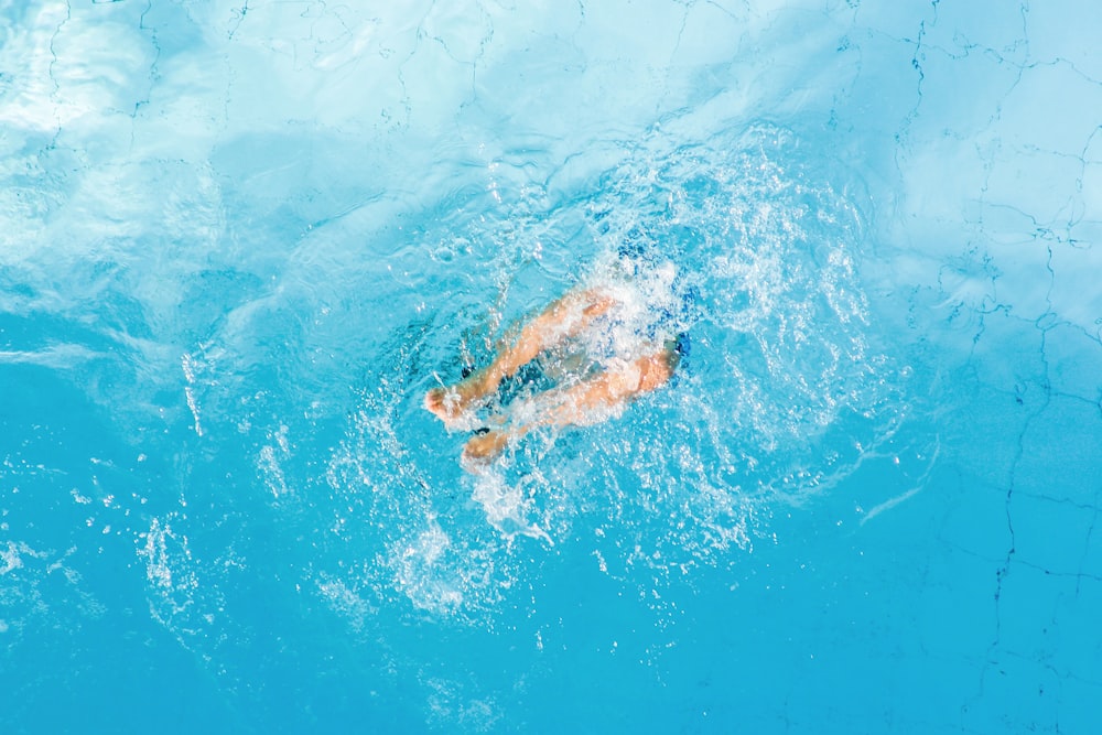 person swimming in blue water