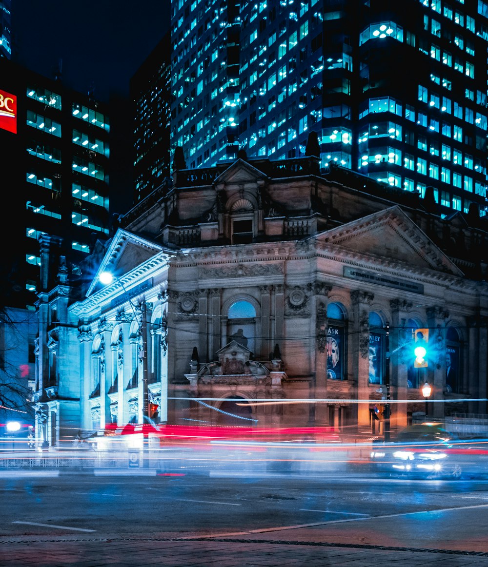 people walking on street near building during night time