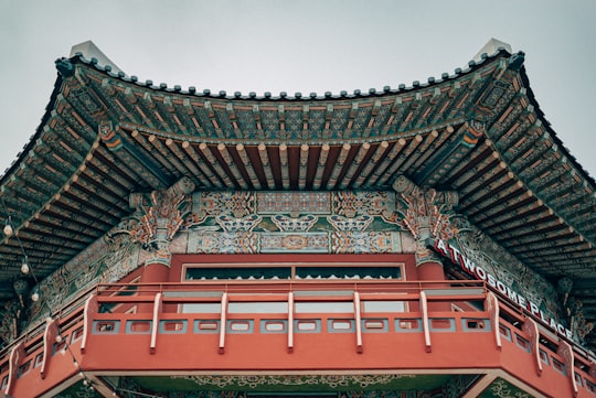 brown and red temple under white sky during daytime in Yongdusan Park South Korea