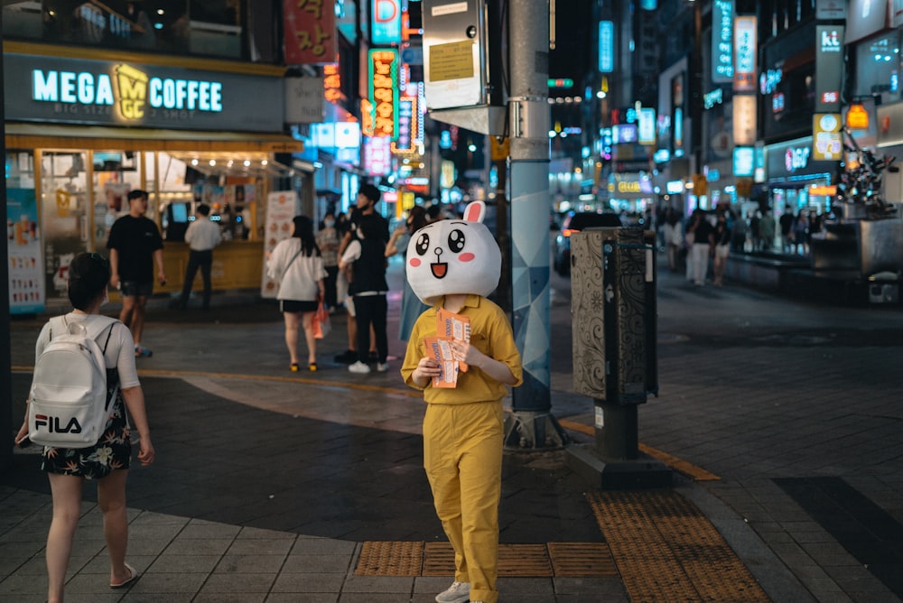 white snowman wearing brown pants standing on sidewalk during daytime