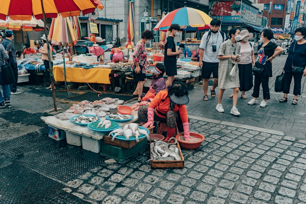 people standing on market during daytime