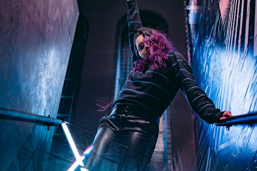 woman in black long sleeve shirt and blue denim jeans standing on stage