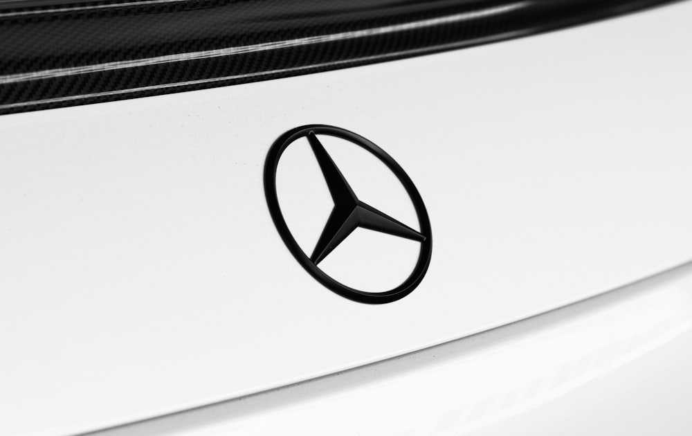 black mercedes benz emblem on white car