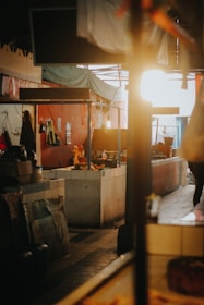 A minimalist market stall with metallic gold accents under soft black matte lighting.