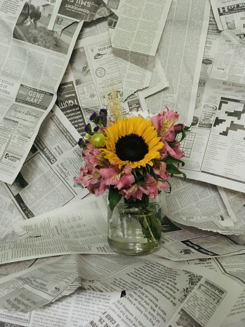 yellow sunflower in clear glass vase