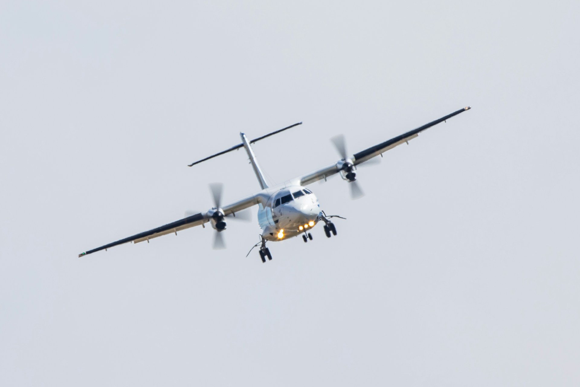 white and yellow plane in mid air