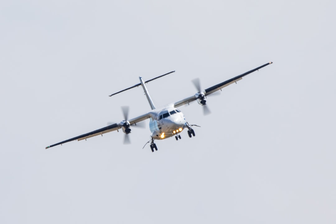 white and yellow plane in mid air