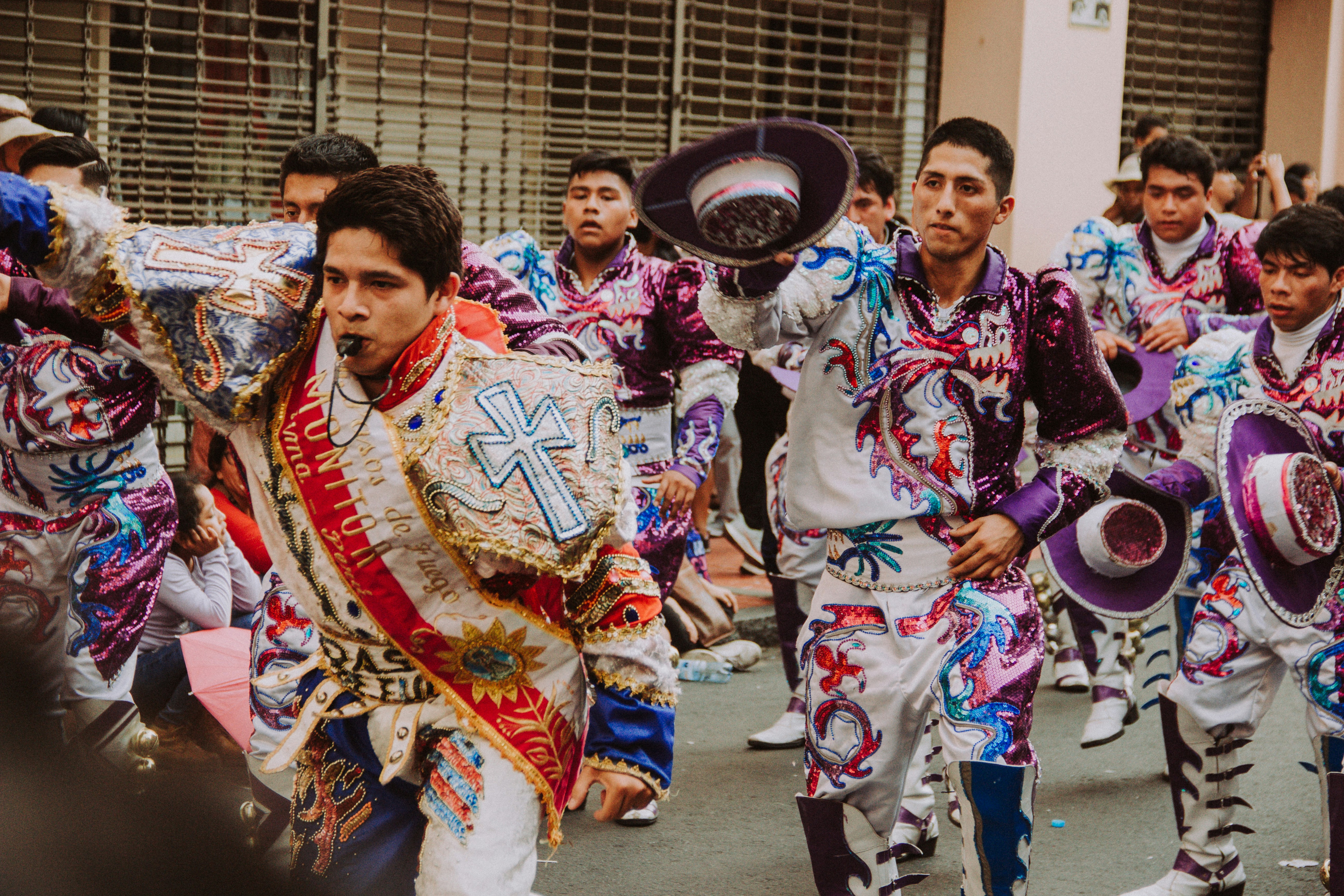 people in traditional dress walking on street during daytime